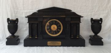 An impressive Edwardian black slate mantle clock of architectural design with a portico,