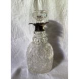 An Edward VII silver topped and cut glass decanter, the flared rim above a hobnail and faceted body,