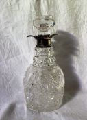 An Edward VII silver topped and cut glass decanter, the flared rim above a hobnail and faceted body,