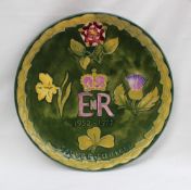 A Moorcroft pottery plate, produced to commemorate the silver Jubilee of Elizabeth II in 1977,