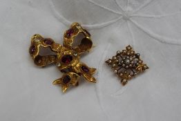 A yellow metal garnet and semi precious set brooch of tied bow design together with a 15ct yellow