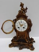 A French ormolu mantle clock, with a cherub surmount, scrolling leaves and swags,