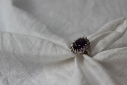 An amethyst and diamond set dress ring,