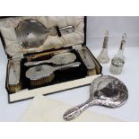 A George V silver backed dressing table set, comprising a pair of hair brushes, clothes brushes,