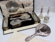 A George V silver backed dressing table set, comprising a pair of hair brushes, clothes brushes,