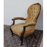 A Victorian mahogany framed Gentleman's chair, with a floral carved cresting rail,