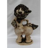John Hughes Pottery Grogg figure of a Centaur, holding a bunch of flowers under his right arm,