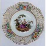 A 19th century Meissen porcelain plate, the rim pierced with a lattice and flowers,