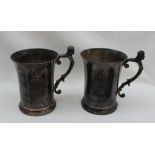 A pair of Elizabeth II silver tankards, the handle with a crowned head and leaves,