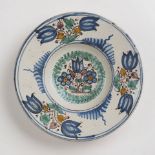 A HABÁN PLATE / 1693, western Slovakia Faïence, white glaze, painted in grand feu colors. Broad