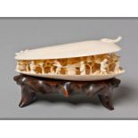 A FINE LATE 19TH CENTURY CHINESE IVORY CARVING OF A MUSSEL SHELL containing a delicately carved