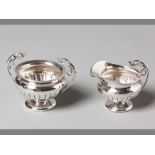 AN EDWARDIAN SILVER SUGAR BOWL AND CREAMER BIRMINGHAM 1908, J & C fold-over rims, applied scroll