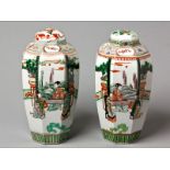 A PAIR OF CHINESE FAMILLÉ VERTÉ OCTAGONAL JARS AND COVERS finely decorated with scenes of court