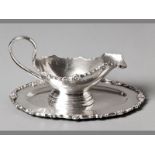 A CONTINENTAL .925 STERLING SILVER SAUCE BOAT BY TAPAZIO with applied floral and swag border,