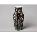 A CHINESE FAMILLE NOIR VASE decorated with flowering branches and green rockwork against a black