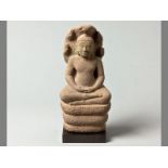 A CAMBODIAN BUFF SANDSTONE FIGURE OF BUDDHA MUCHALINDA seated in virasana on the coils of the