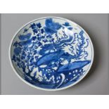 A CHINESE KANGXI PERIOD SAUCER DISH decorated in a vivid tone of underglaze blue with two phoenix