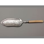 A LATE 19TH CENTURY SILVER & BONE HANDLED FISH SLICE engraved “W.I”, the slice engraved and embossed