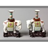 A PAIR OF LATE 19TH CENTURY CHINESE CANDLESTICKS in the form of elephants, with candle sconces,