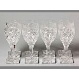 A SET OF EIGHT 19TH CENTURY WINE GLASSES diamond pattern on square bases, some chips, (8).