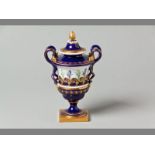 A ROYAL WORCESTER PEDESTAL URN decorated with a band of snowdrops and crocus between Serves blue