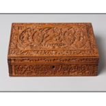 A FINELY CARVED MID-19TH CENTURY SANDALWOOD INDIAN CASKET decorated with mythical figures to the lid