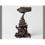 A CHINESE PATINATED ROOTWOOD FIGURE OF GUANYIN seated beneath a lingzhi mushroom, on a gnarled