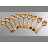 A SET OF NINE GEORG JENSEN STERLING SILVER GILT COLLECTORS SPOONS, 1971-1979, each spoon handle