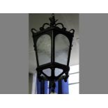 A WROUGHT IRON GLAZED HANGING LANTERN