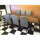 A oak refectory table and six high backed dining chairs.