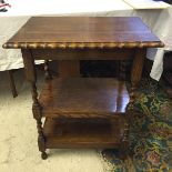 A three tier oak side table.