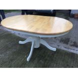 An extending dining table with painted base.