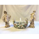 A pair of 19 th century figurines and a basket with repair stapling.