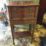 A cuttlery cabinet of four drawersin mahogany with boxwood inlay containing a Walker and Hall