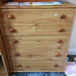 A pine five drawer chest of drawers.