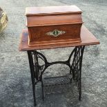 A singer sewing machine with cast iron table.