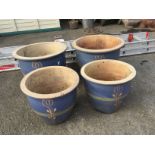 Four matching blue garden pots.