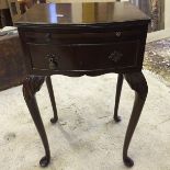 A small side table with Queen Anne legs wit brushing shelf over one drawer.