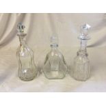 Three decanters with stoppers.