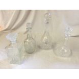 Four decanters with stoppers.