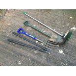 A garden spade, fork, edgers and a stiff