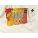 A set of four champagne flutes.