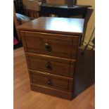 A bedside chest of drawers.