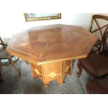 An octagonal fruit wood table with stone inlay.