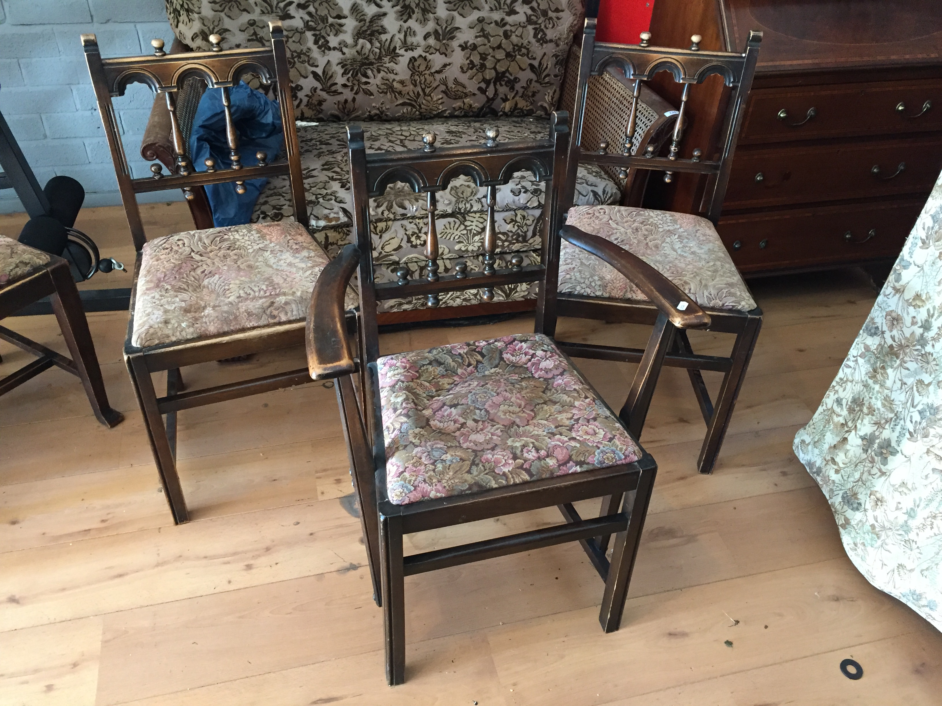 Three dining chairs with pop out seats.