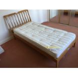 A single bed with mattress.