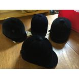 Four riding hats unused sizes as shown.