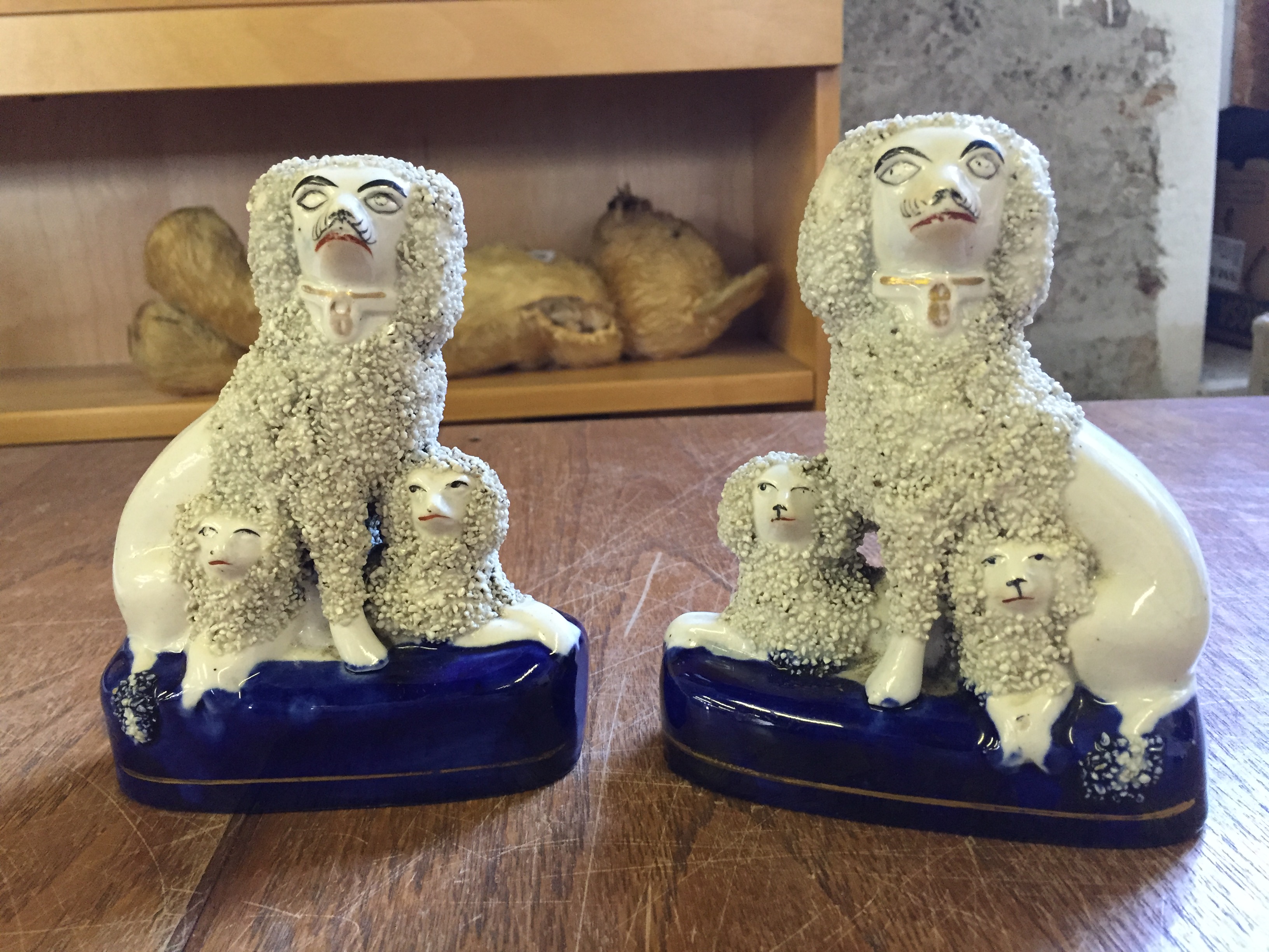 A pair of small Staffordshire poodles with puppies circa 1850 140 mm H