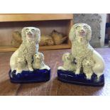 A pair of small Staffordshire poodles with puppies circa 1850 140 mm H