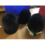 Three riding hats unused sizes as shown.